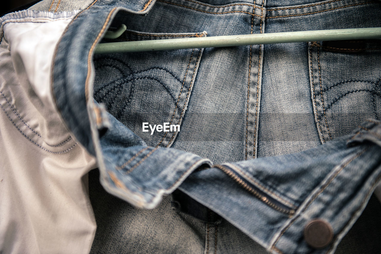 Close-up of jeans hanging from coathanger