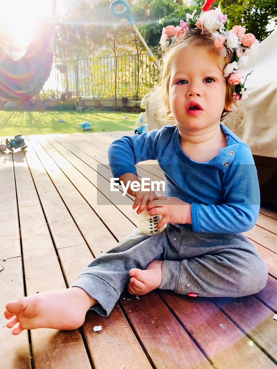 Portrait of cute girl while sitting outdoors