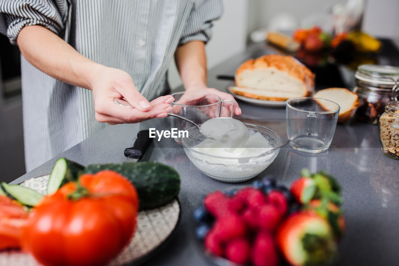 Midsection of man preparing food on table