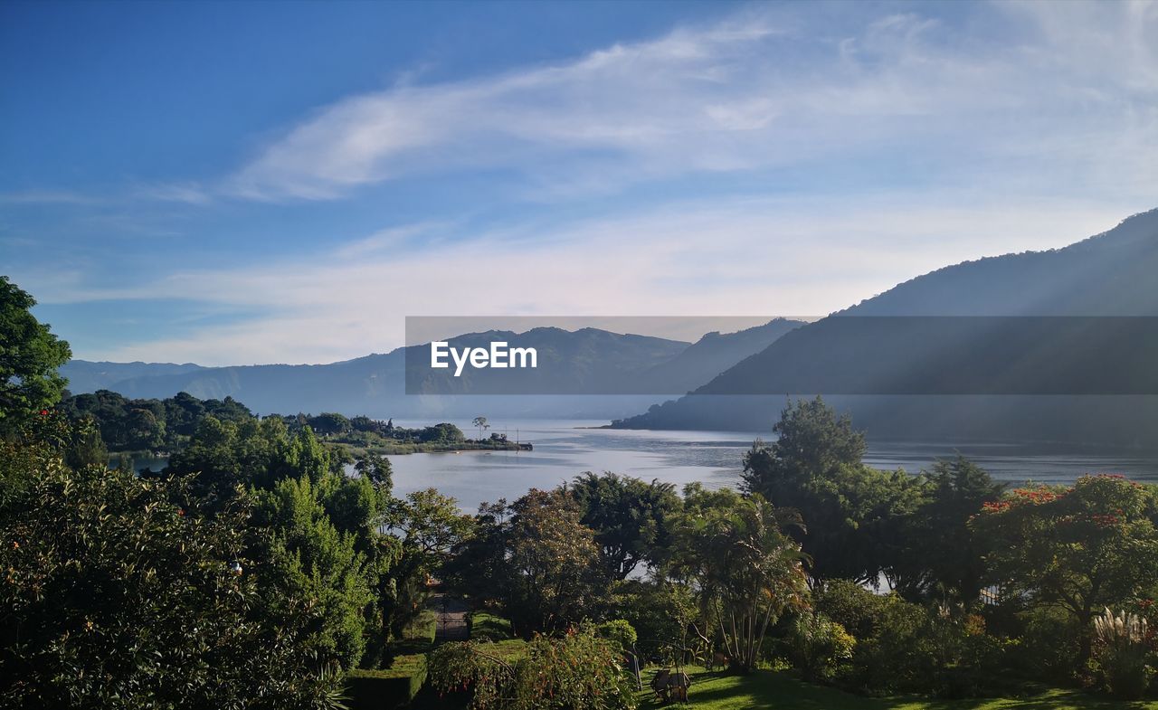 Scenic view of lake and mountains against sky