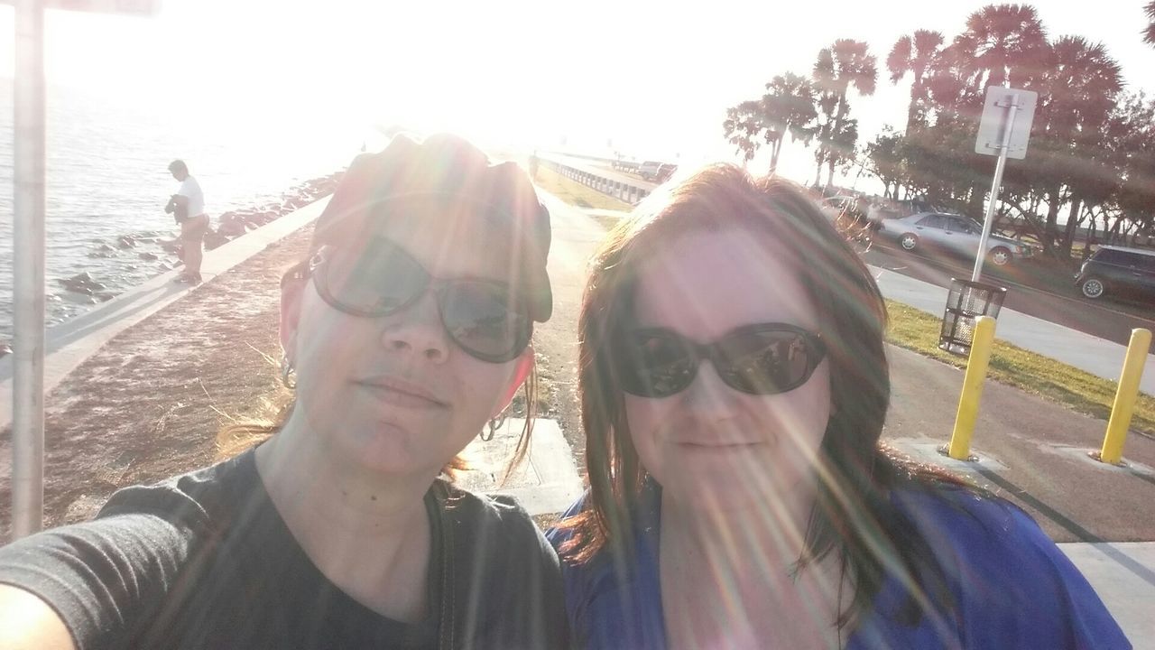 Portrait of female friends wearing sunglasses on sunny day