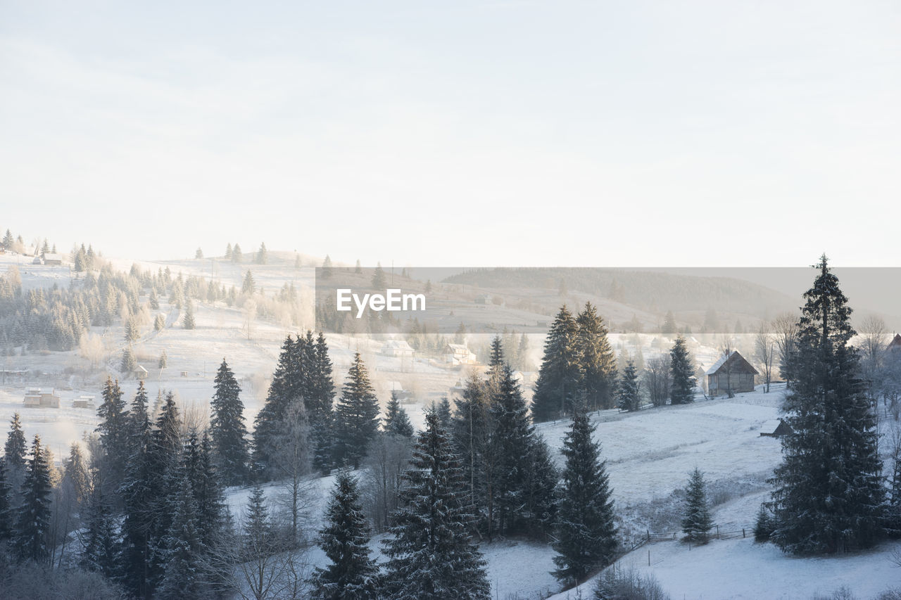 SCENIC VIEW OF SNOW COVERED LAND AGAINST SKY