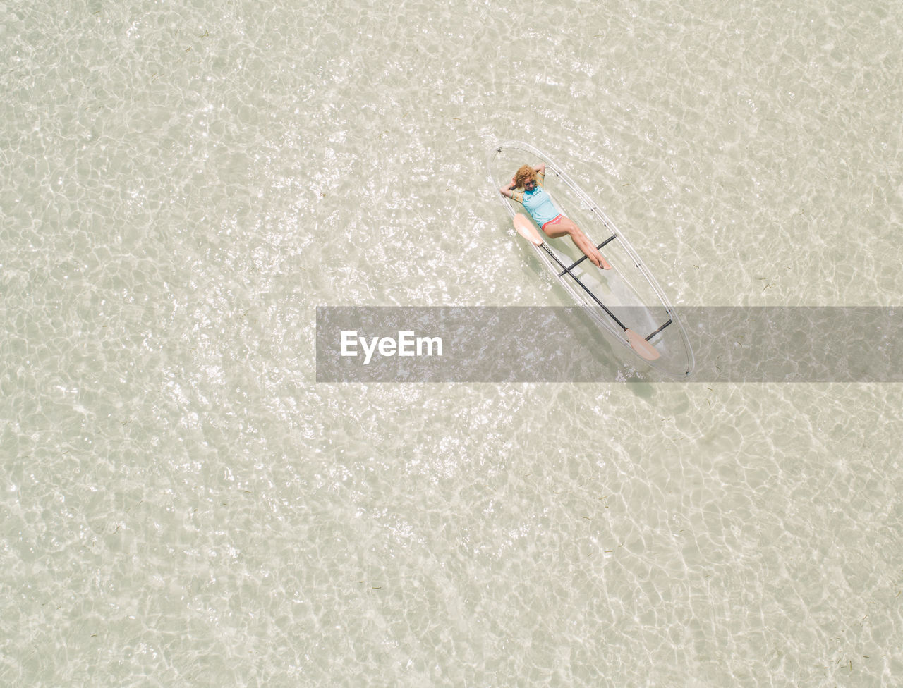 Aerial view of woman kayaking in sea