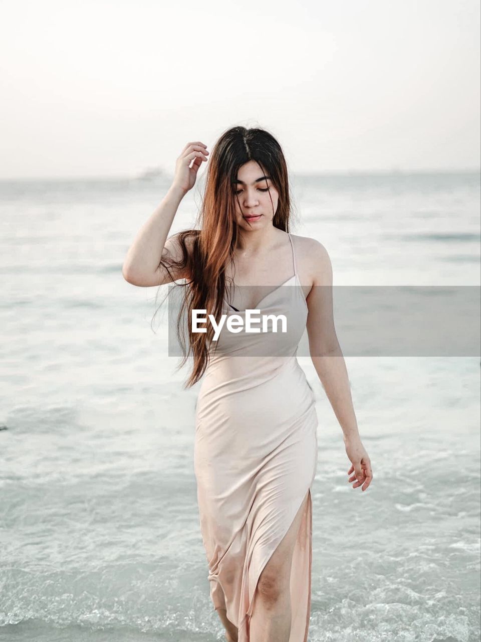 Young woman standing at beach