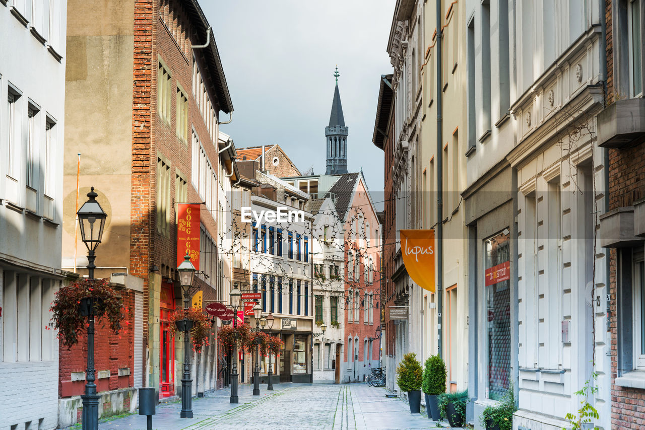 Street amidst buildings in city against sky