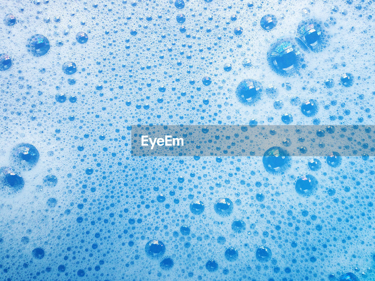 CLOSE-UP OF BUBBLES IN BLUE WATER