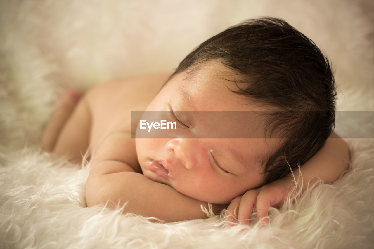 Cute baby boy sleeping on fur