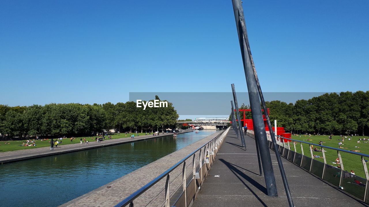 BRIDGE OVER RIVER AGAINST CLEAR BLUE SKY