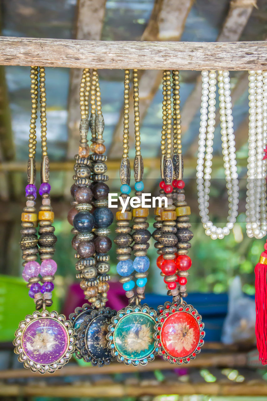 Close-up of decorations hanging at market stall