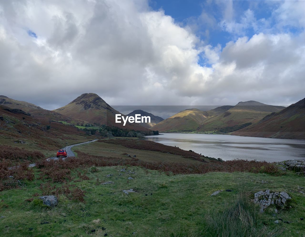 Scenic view of land and mountains against sky