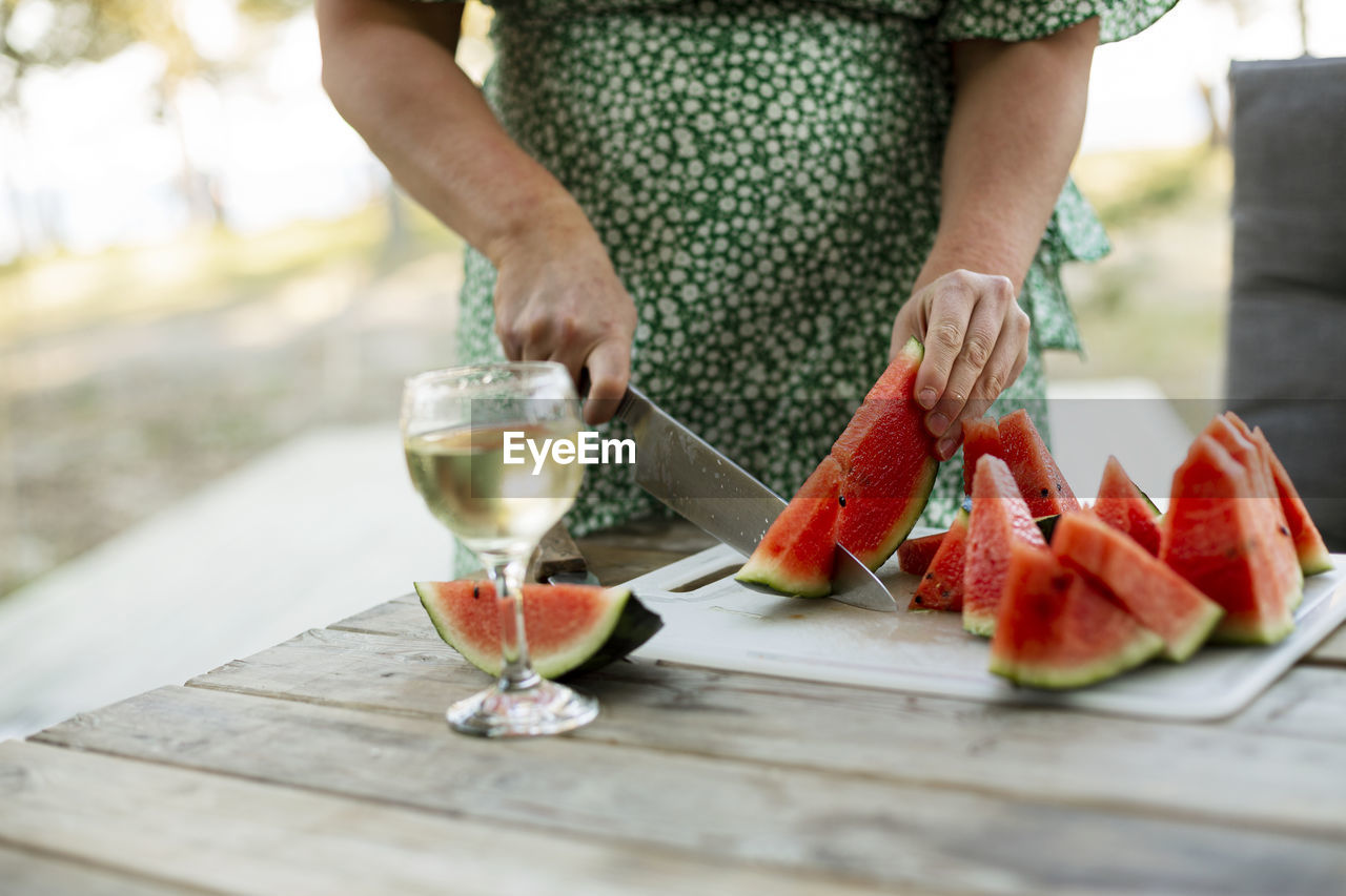 Woman cutting watermelon