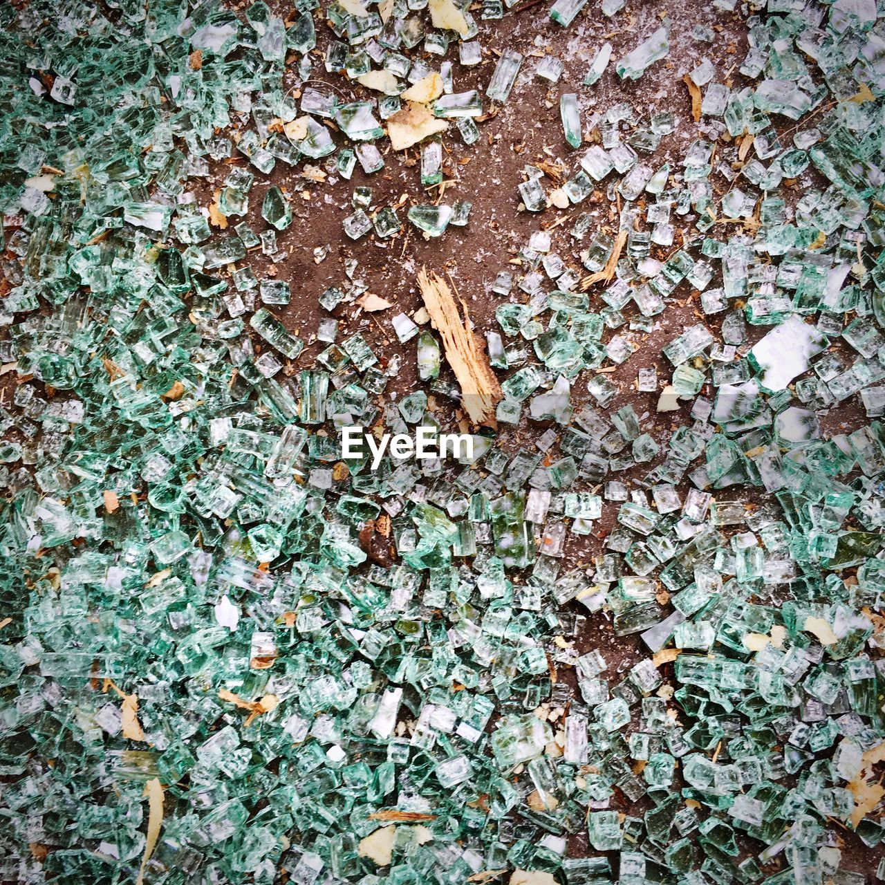 High angle view of broken glass on land