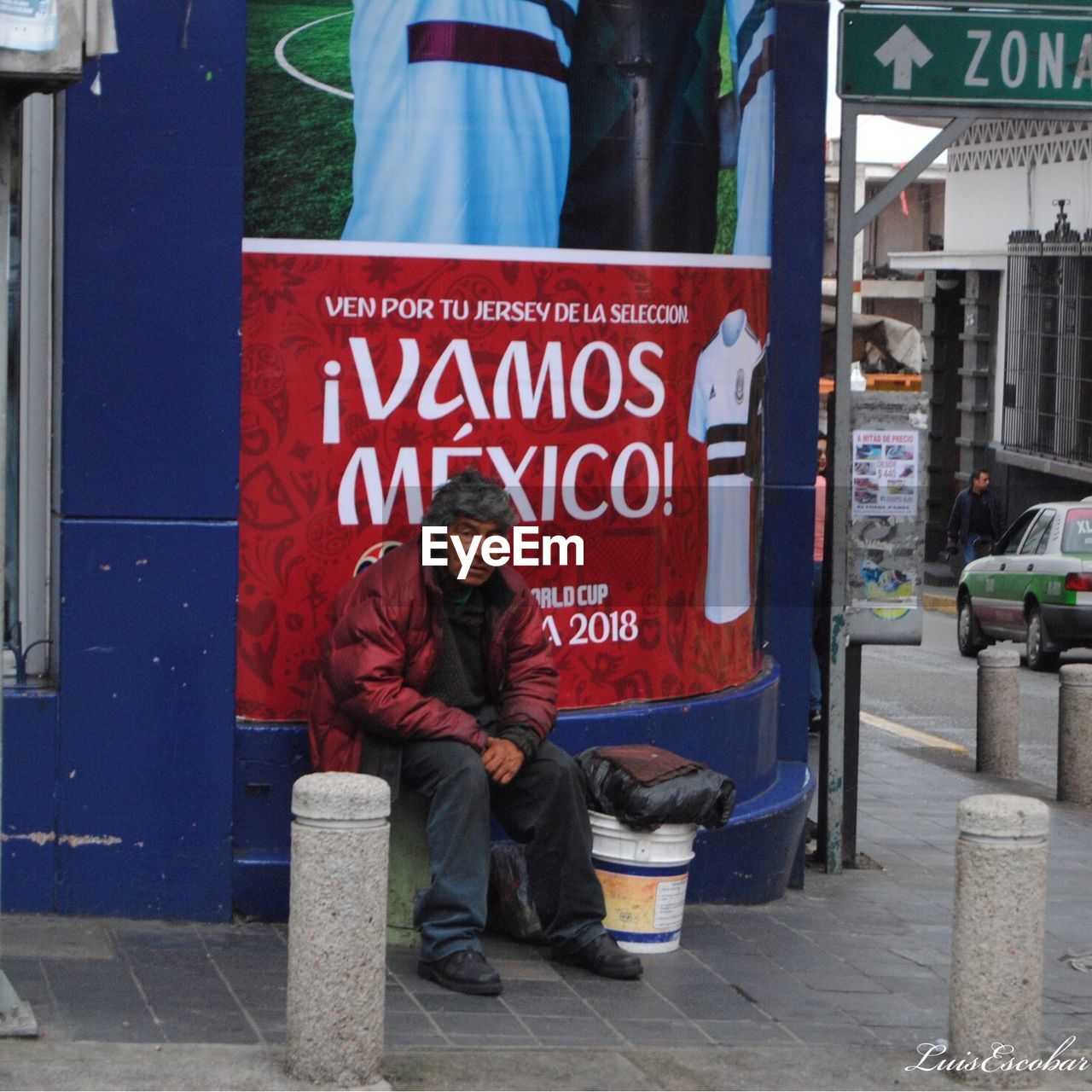 FULL LENGTH OF MAN SITTING ON STREET