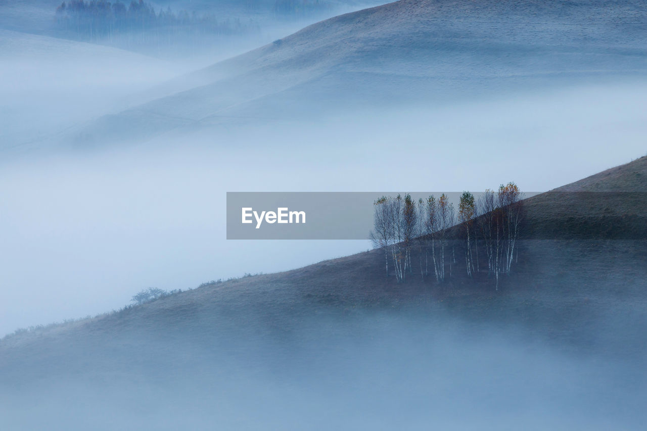 Scenic view of mountains during foggy weather