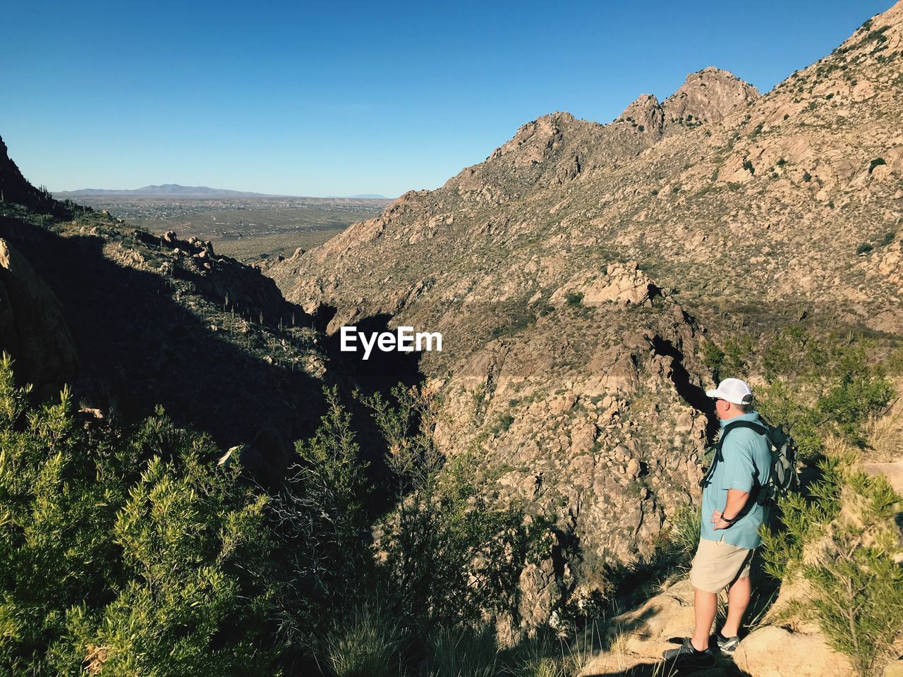 High angle view of man standing against mountains