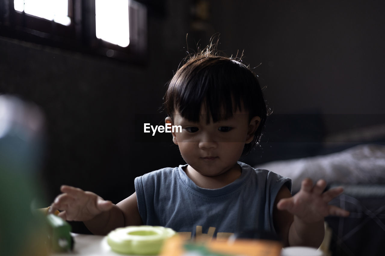 portrait of cute girl eating food at home