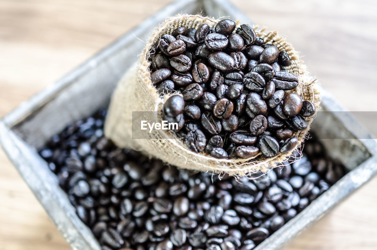 HIGH ANGLE VIEW OF COFFEE BEANS IN GLASS