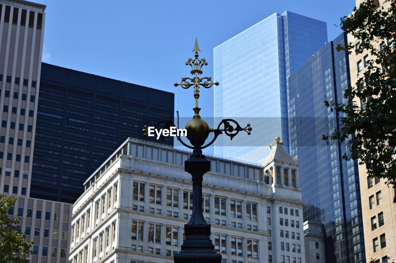 Low angle view of buildings against clear blue sky