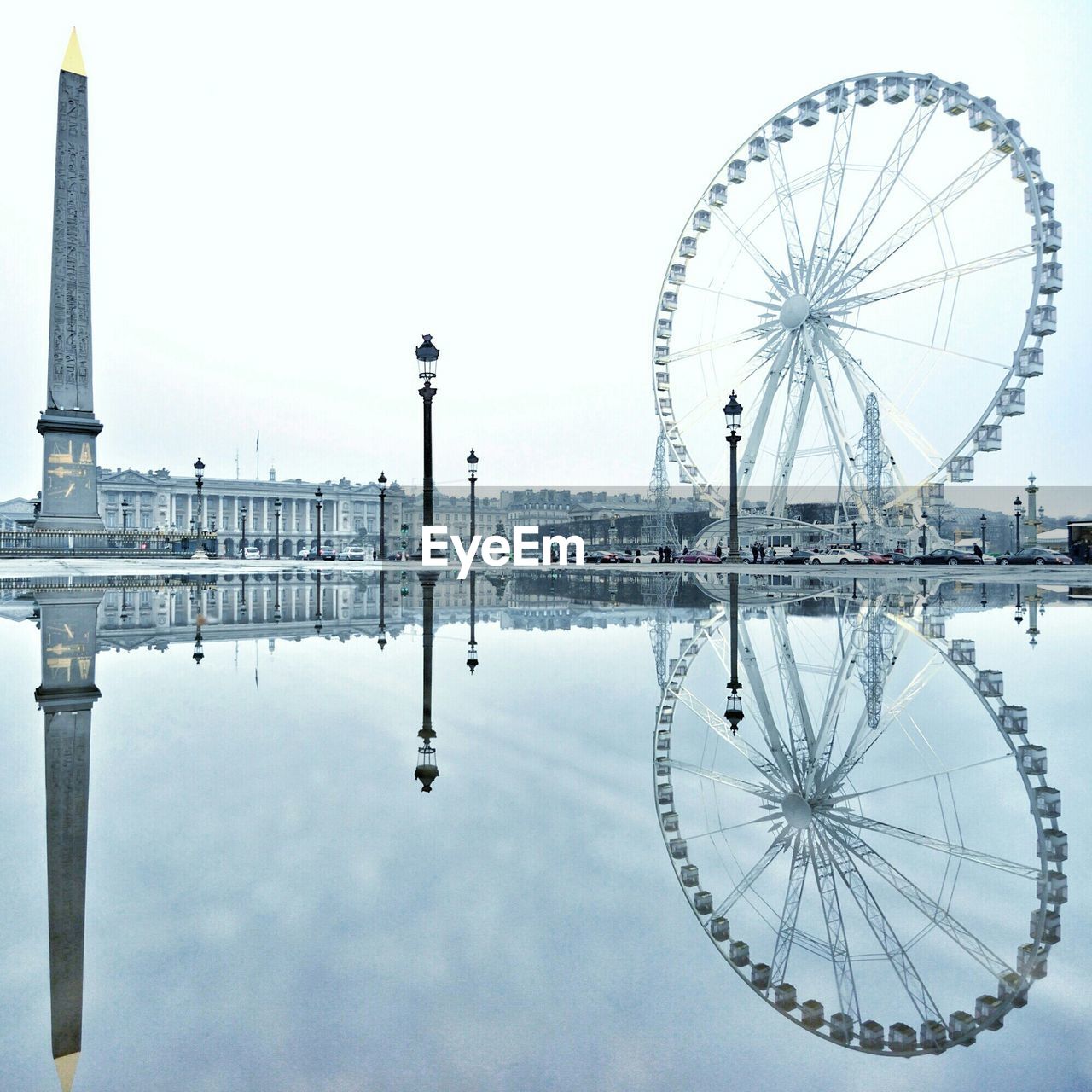 Column monument and ferris wheel by reflecting pool