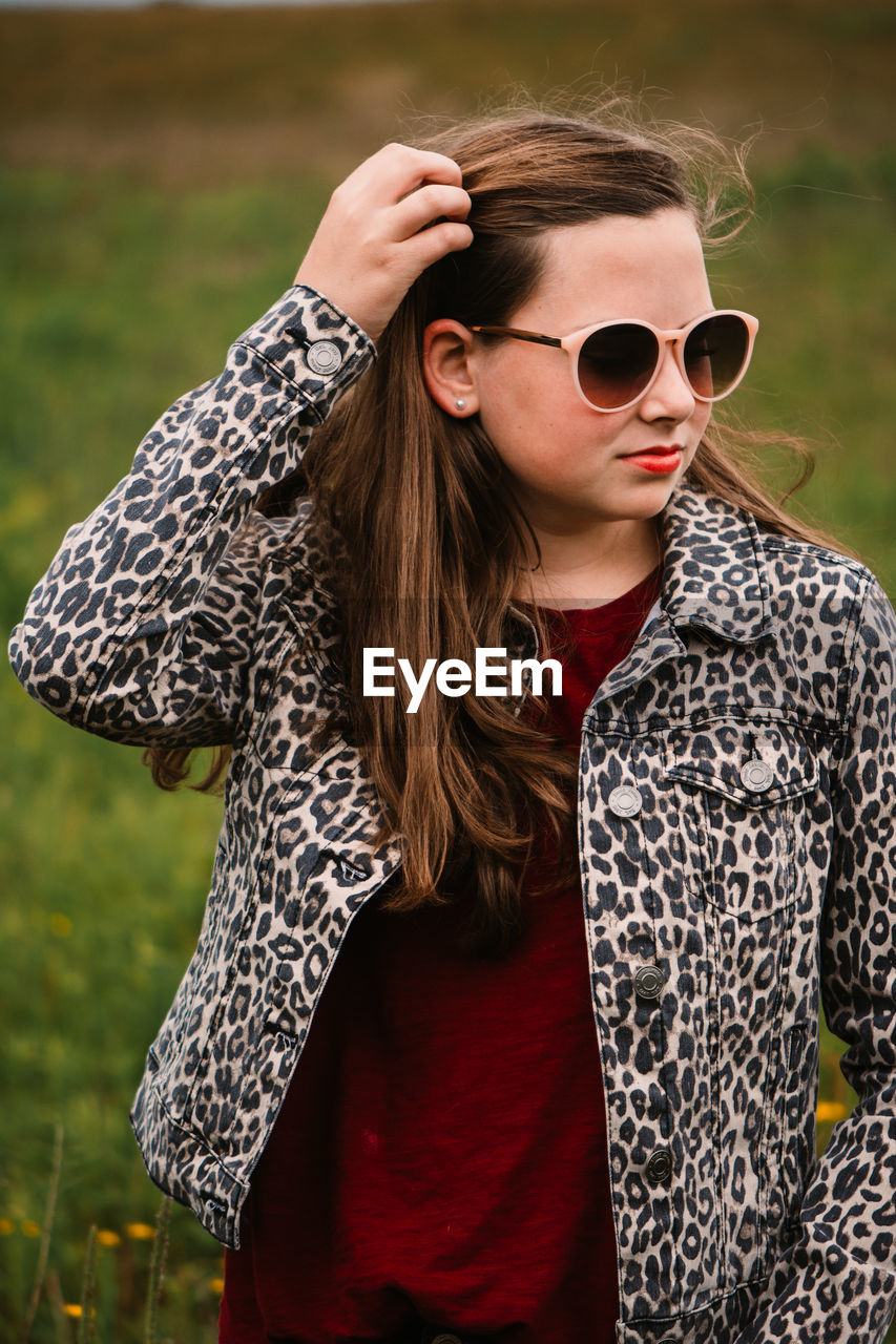 Young woman wearing sunglasses standing outdoors