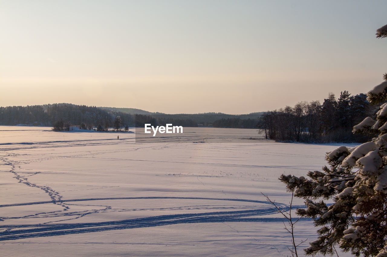 Scenic view of frozen lake against sky during winter