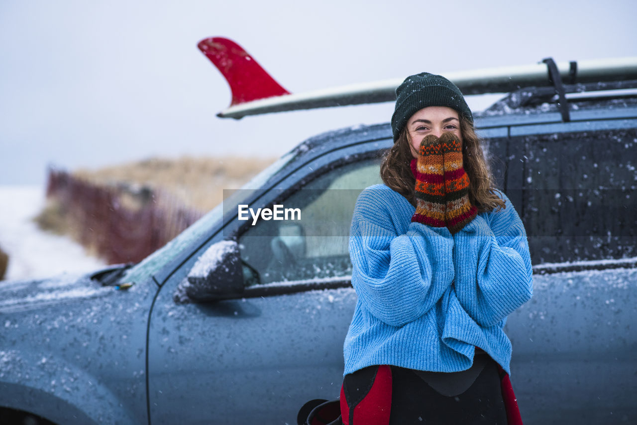 Woman surfer portrait with frozen surfboard