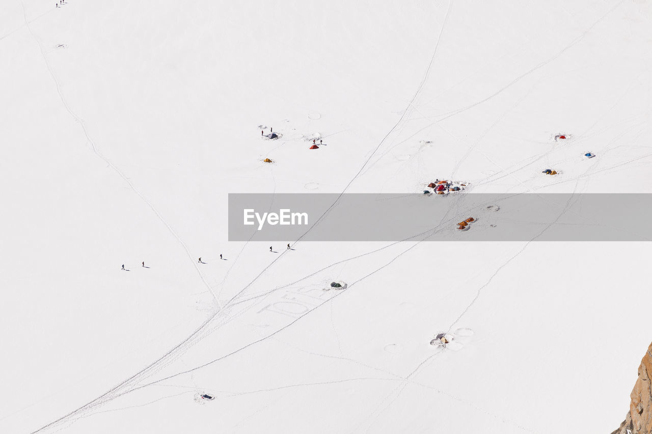 HIGH ANGLE VIEW OF PEOPLE ON SNOW COVERED LANDSCAPE