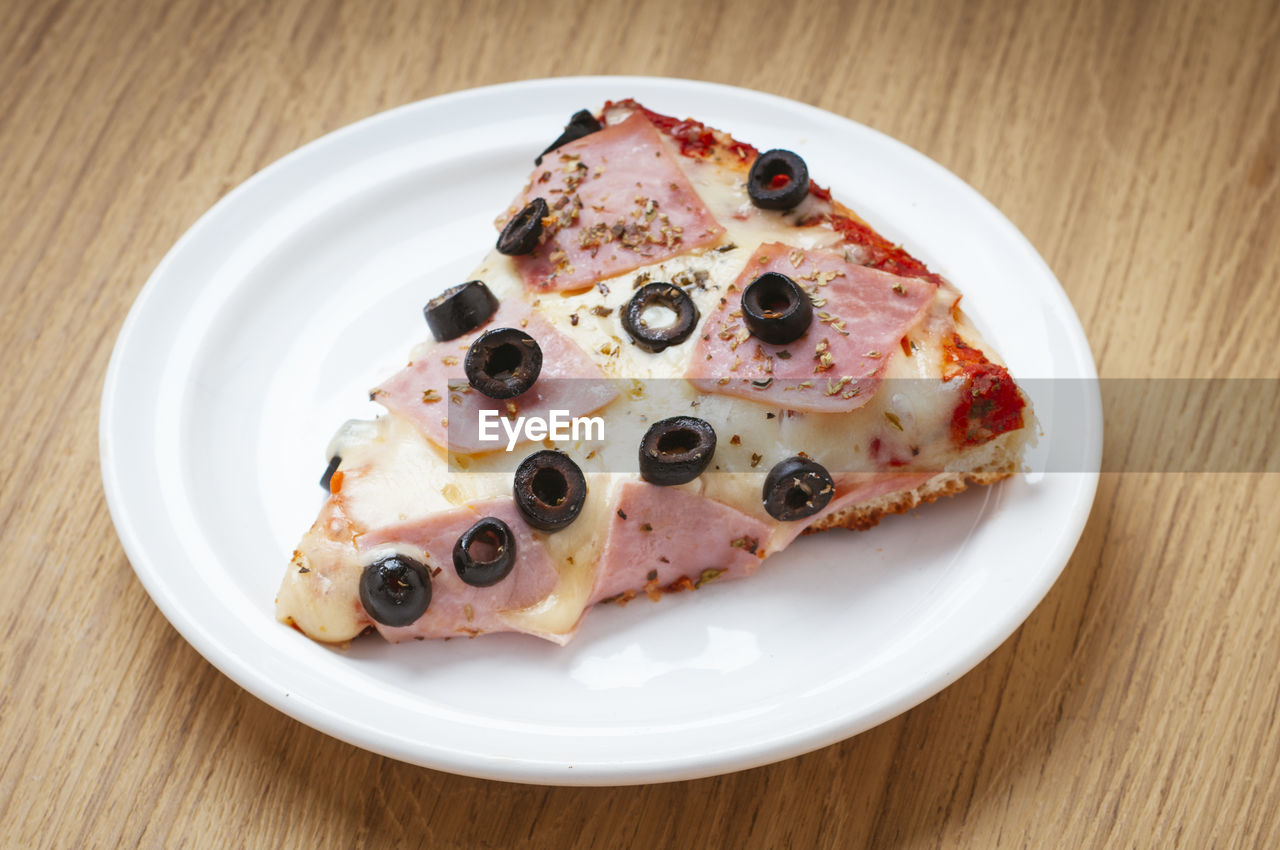 High angle view of pizza in plate on table