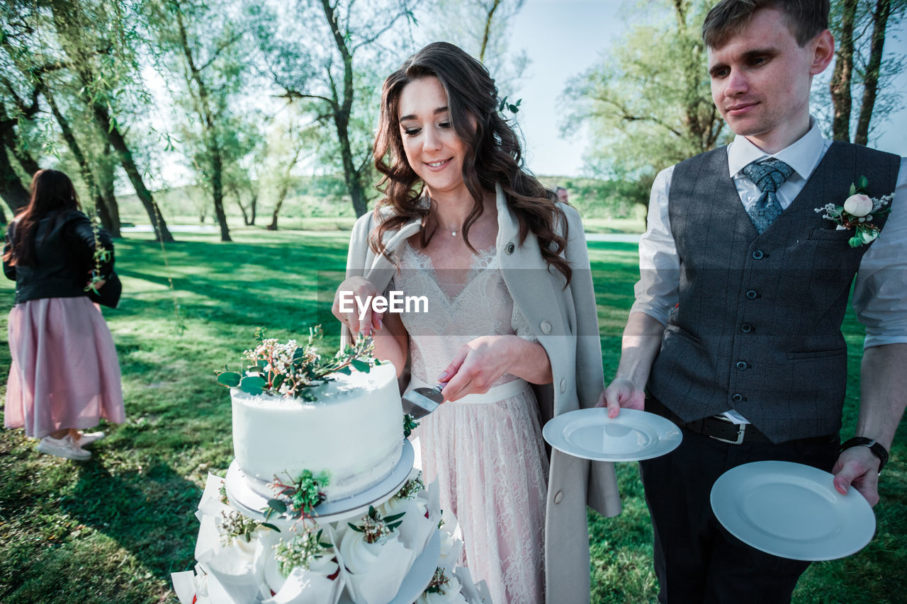 Couple cutting cake during wedding ceremony
