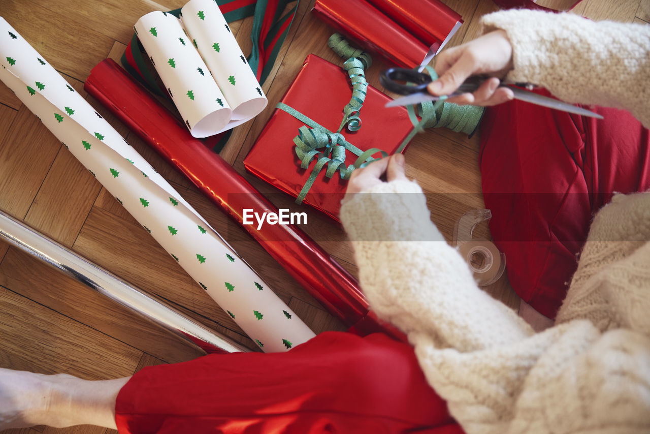 Woman's hands packing christmas presents