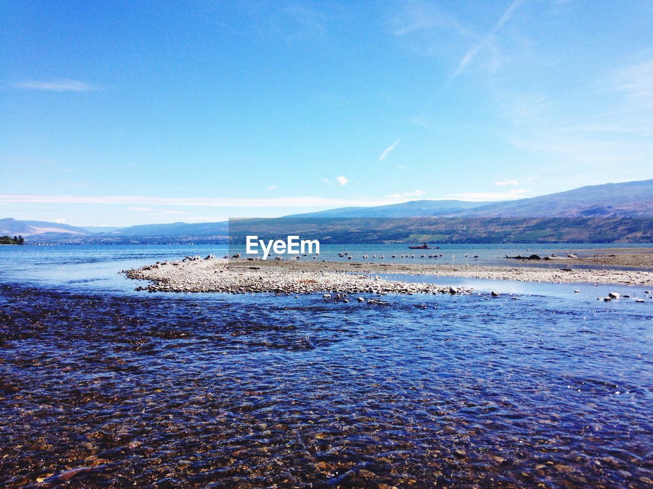 Scenic view of sea against blue sky