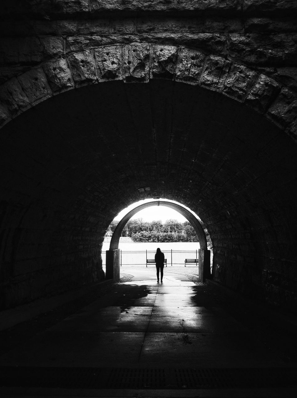 Silhouette woman standing in tunnel