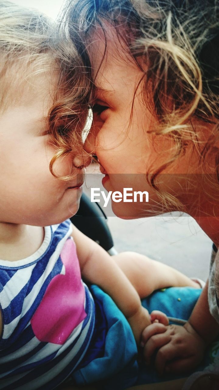 Close-up of boy embracing sister