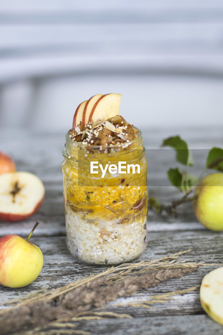 Apple porridge in jar with fruits on table 