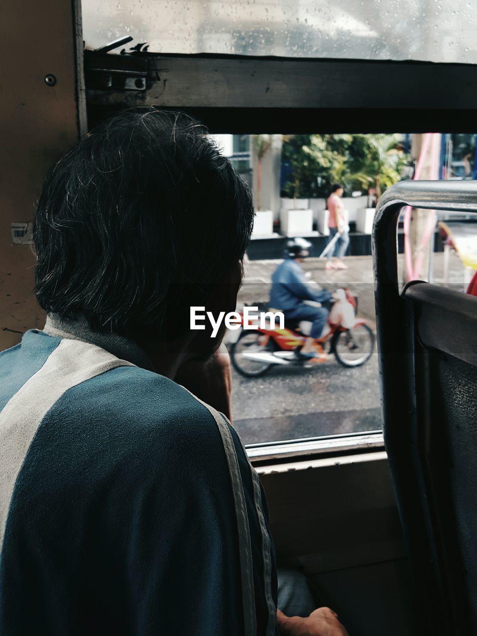 Rear view of man sitting in bus