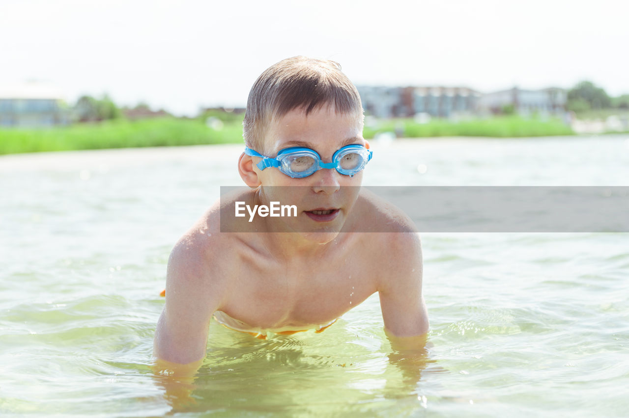 Portrait of shirtless boy in swimming pool