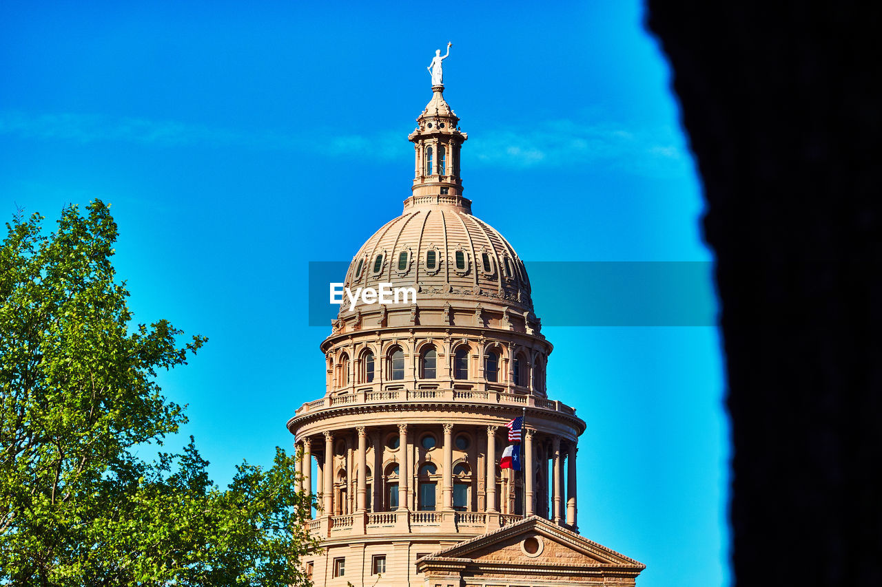 Low angle view of texas congress building against blue sky