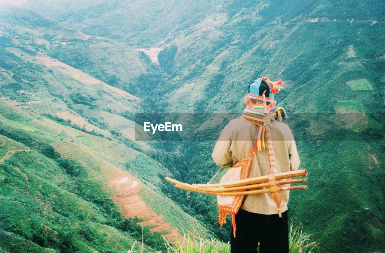 Rear view of man standing on mountain