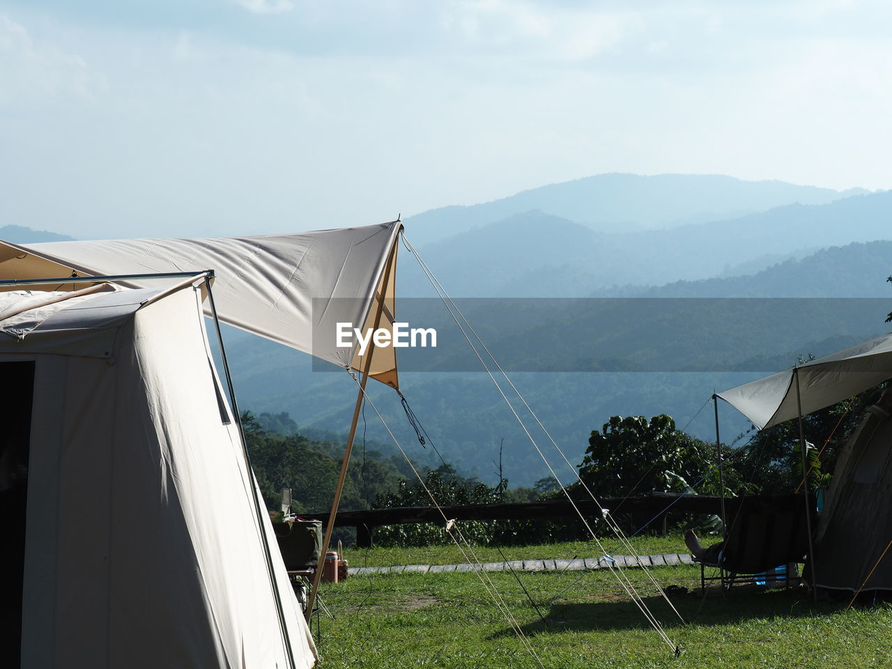 sky, nature, tent, mountain, environment, plant, architecture, grass, built structure, no people, landscape, day, beauty in nature, scenics - nature, mountain range, land, building exterior, outdoors, tranquility, building, house, cloud, sunlight, field, camping, tranquil scene