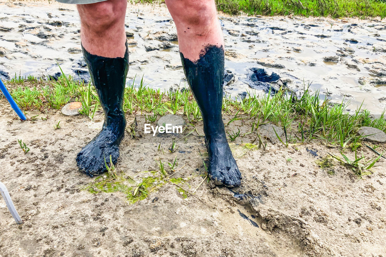 low section of man standing on dirt