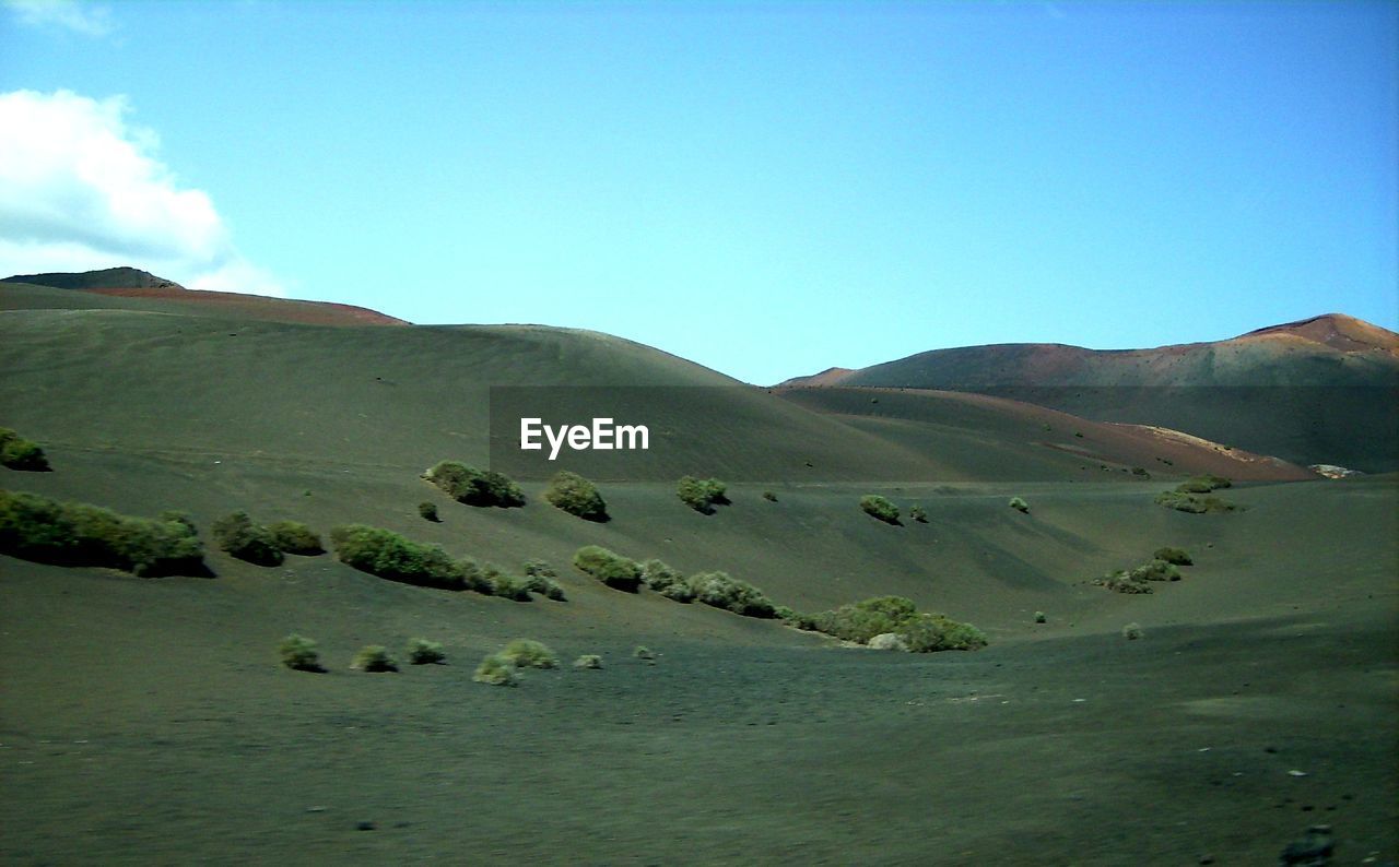 SCENIC VIEW OF ARID LANDSCAPE AGAINST CLEAR BLUE SKY