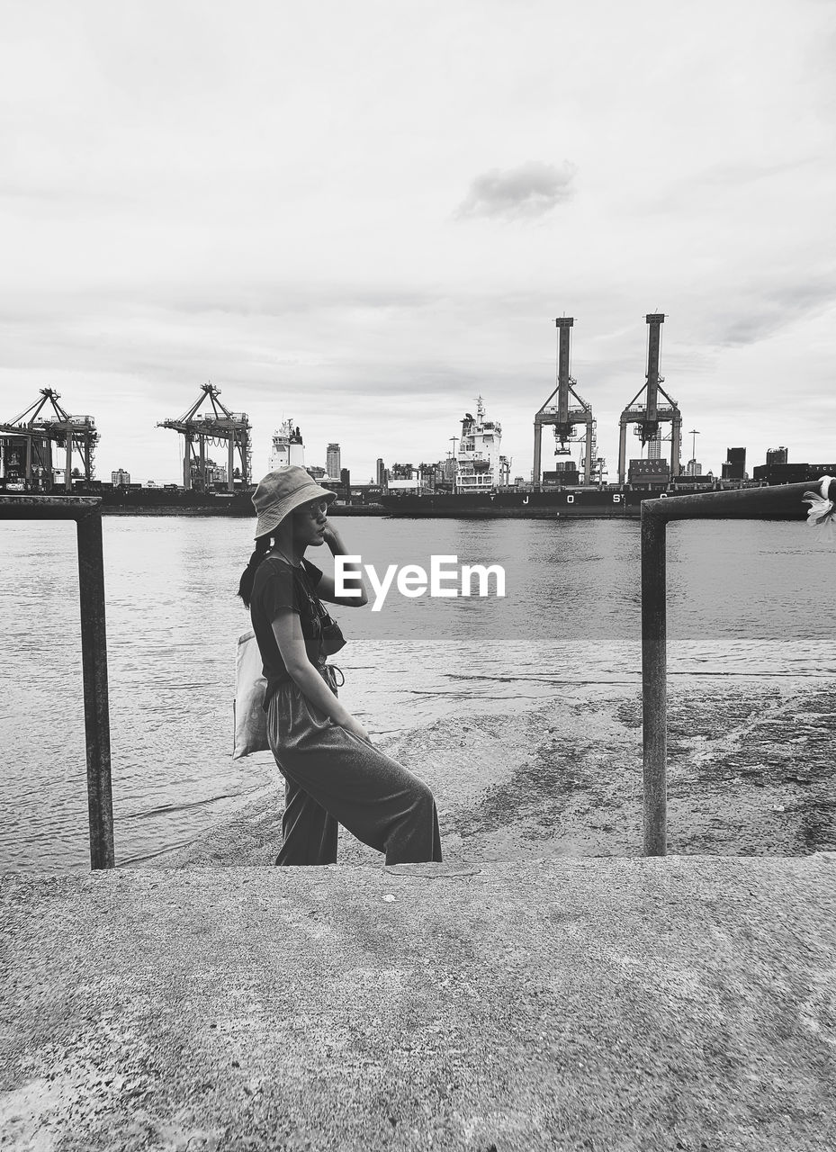 A woman standing at a former famous pier near bangkok on sunny day