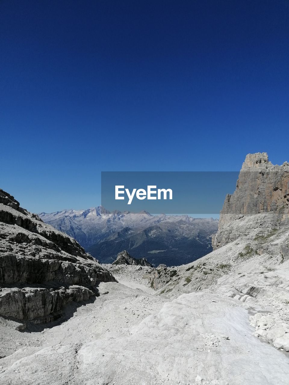 Scenic view of mountains against clear blue sky