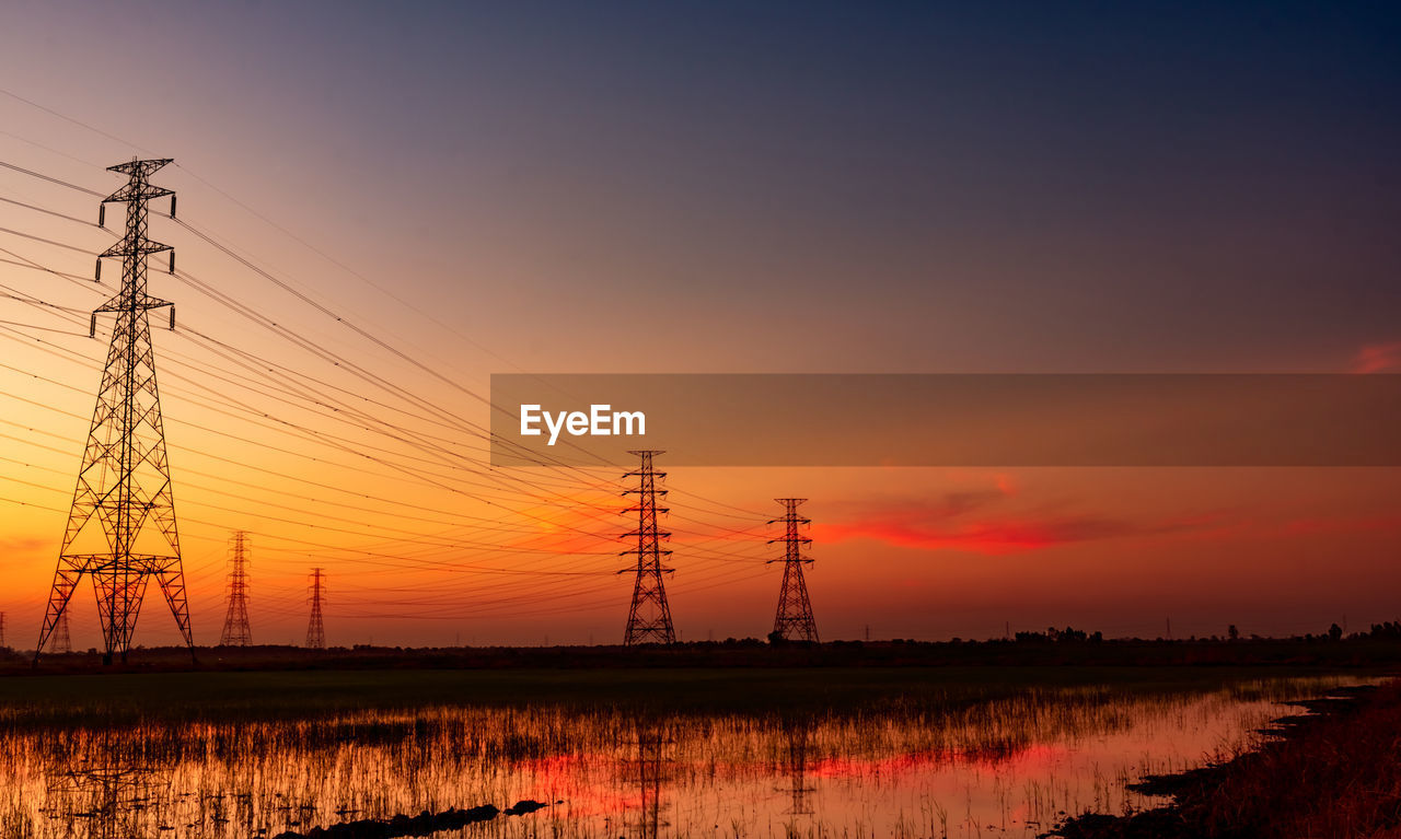 High voltage electric pylon and electric wire against sunset sky. electricity pole.