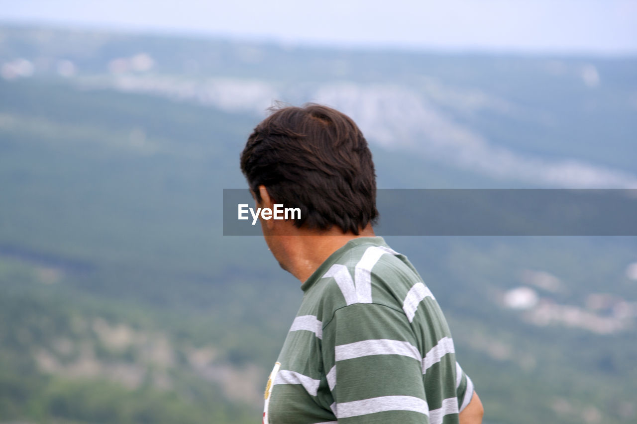 Man against mountains and sky