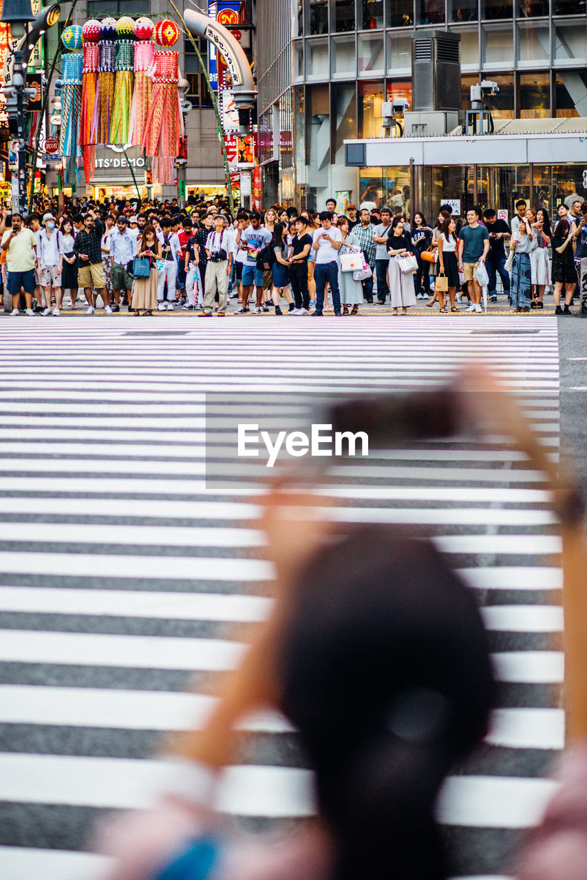 BLURRED MOTION OF PEOPLE WALKING ON STREET