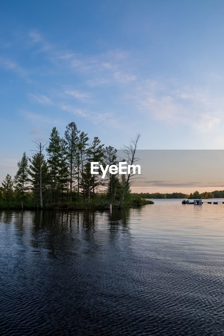 SCENIC VIEW OF LAKE AT SUNSET