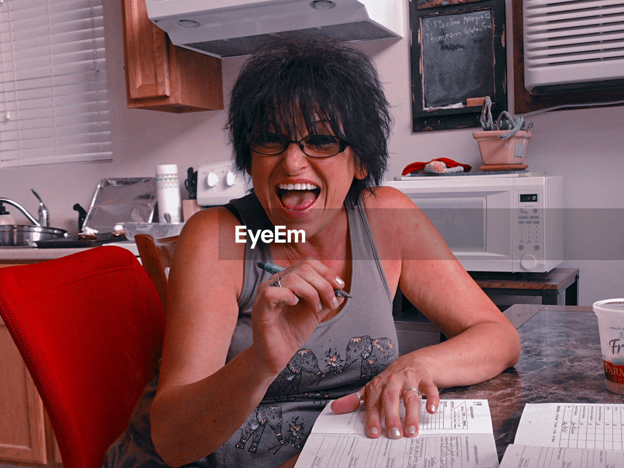 Portrait of a smiling young woman sitting at home