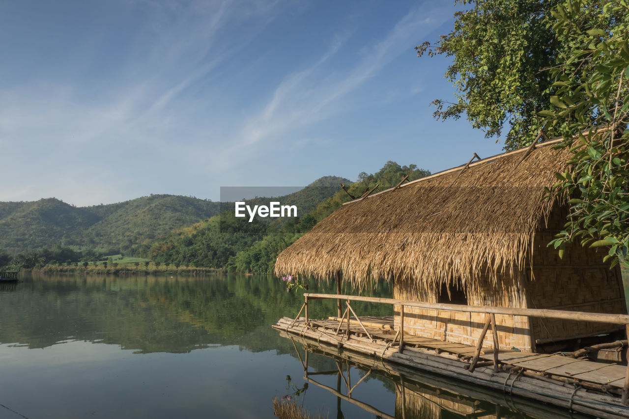 Scenic view of lake by building against sky