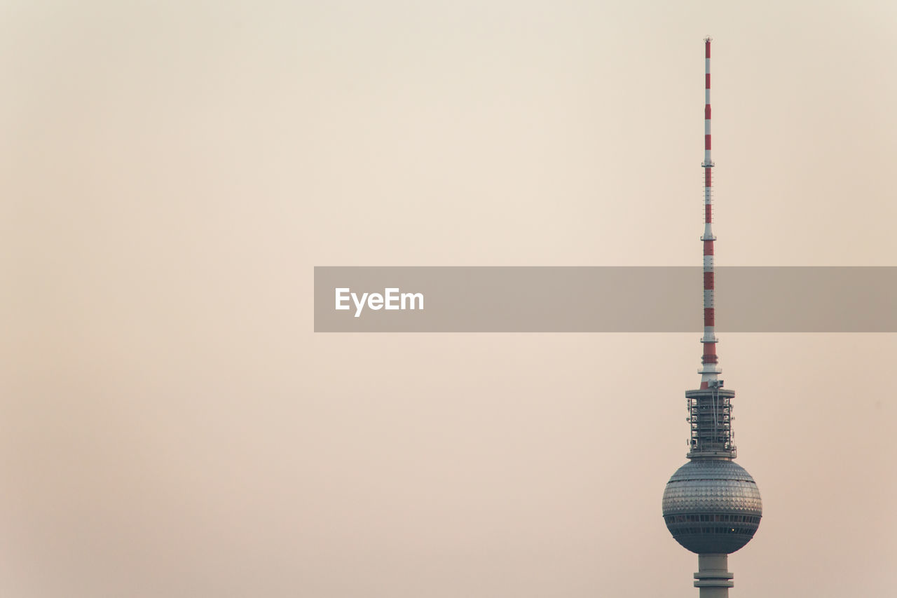 High section of fernsehturm television tower against clear sky during sunset